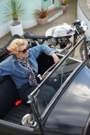 Sarah Bradley sitting in a vintage car